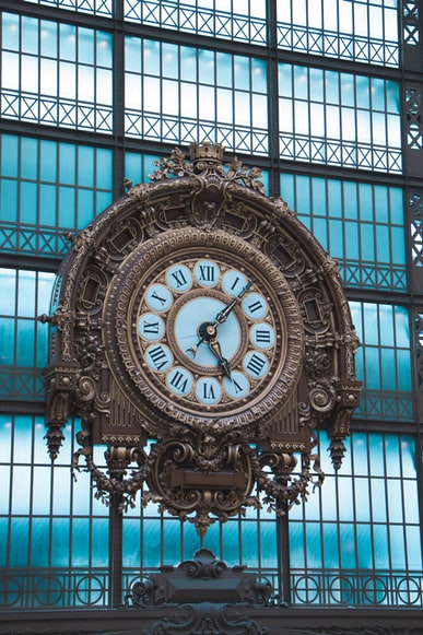 The Essence Of ‘Time’ virtual assistant blog. The image is of a large clock at a train station or similar