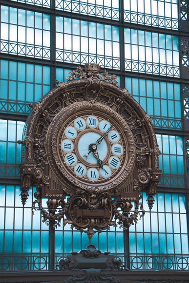 The Essence Of ‘Time’ virtual assistant blog. The image is of a large clock at a train station or similar